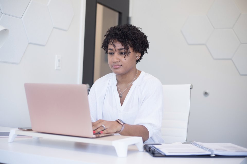 A business owner working on her laptop at her desk